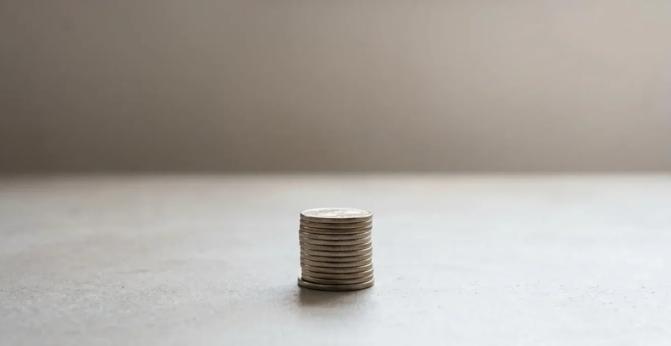 Abstract visual representation of business financial planning with stacked coins creating a protective buffer against uncertainty in minimalist composition