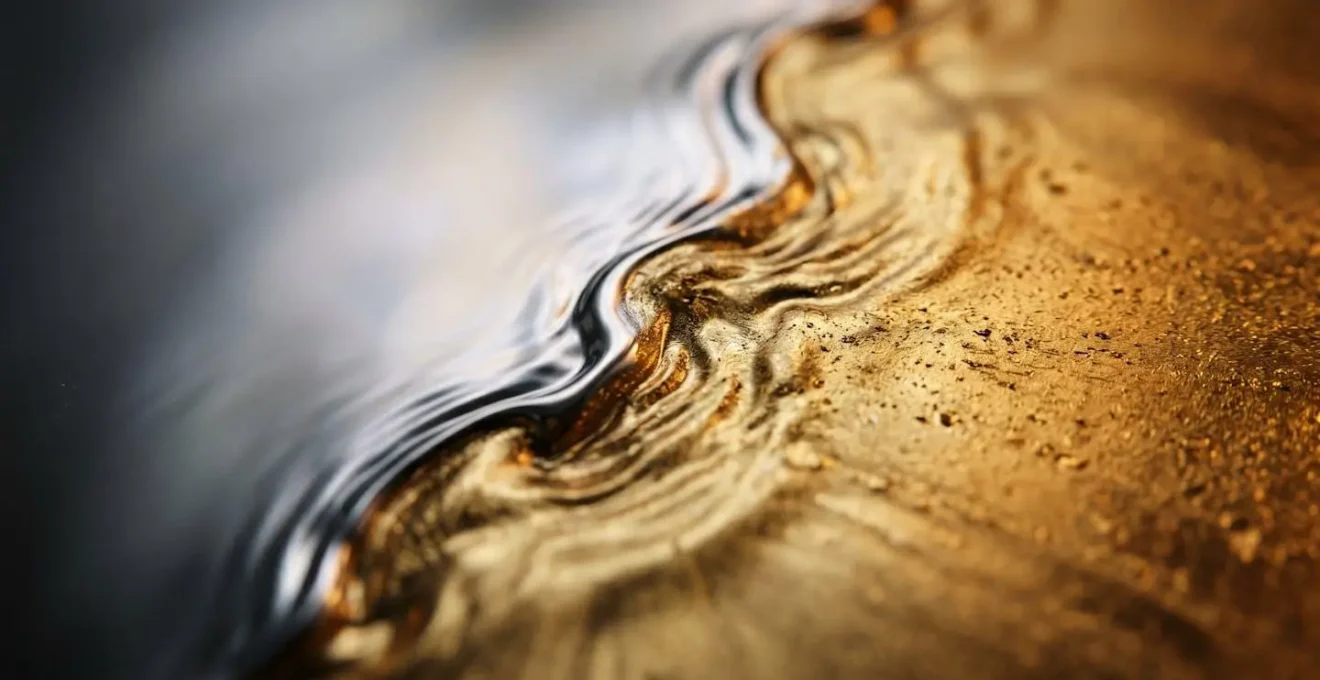 Macro detail of currency exchange rate fluctuation represented through abstract flowing liquid metal textures